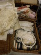 Two wicker baskets containing various lace panels and trim, various ribbons, braiding etc.