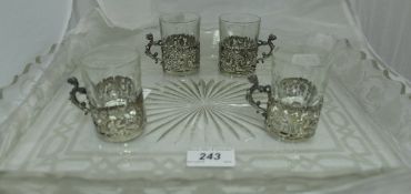 A set of four glasses with pierced silver mounts, etched and cut glass tray,