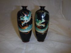 A pair of Meiji period Japanese cloisonné vases dark blue ground decorated with three-toed dragons,