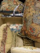 A collection of needlework type scatter cushions together with two velum suitcases and a further