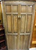 An oak linen fold small wardrobe together with a 20th Century yew corner cabinet and a large pine