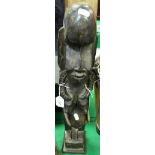 A carved African female fertility figure