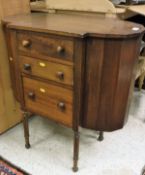 An American circa 1900 mahogany work cabinet with three drawers flanked by two faceted D-end