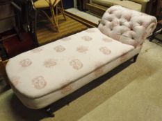 A Victorian day bed with buttoned scrolled back pink upholstery with embroidered classical images