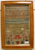 An early 19th Century needlework sampler with simple letters and numbers,