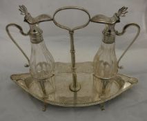 A late Victorian silver mounted facet cut glass oil/vinegar bottle set upon a boat shaped pierced