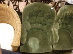 A pair of Victorian armchairs with green velvet upholstery,