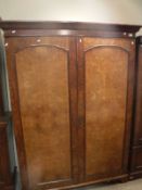 An early 20th Century burr walnut veneered two door wardrobe