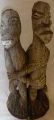 An ethnic carved wooden figure group of an embracing couple