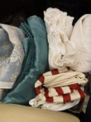 A box of assorted textiles to include two throws, table cloth etc.