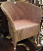 Four items of Lloyd Loom dusty pink sprayed finish to include tub chair, stool, baskets etc.