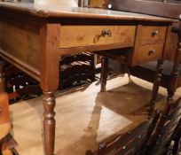 A modern mahogany desk with three short drawers raised on turned legs in the 19th Century manner