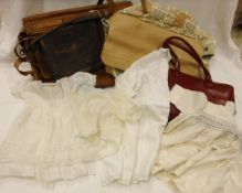 Two boxes of sundry textiles and handbags to include various children's clothes etc.