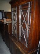 A mahogany display cabinet with two glazed doors above two panelled cupboard doors (a marriage)