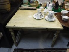 A modern yellow painted pine farmhouse style kitchen table in the Victorian manner