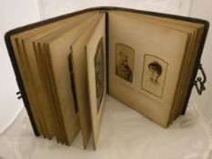 A Victorian leather photograph album and contents of assorted portrait photographs etc.