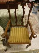 A pair of carved oak Flemish style elbow chairs