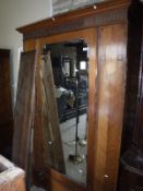 An Edwardian mahogany and inlaid single mirror door wardrobe with drawer