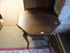 A pair of wing back armchairs with cabriole front legs together with a mahogany octagonal centre