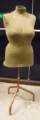 A mid 20th Century tailor's dummy raised on a metal tripod base