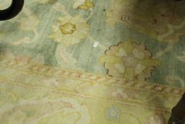 A Ziegler design carpet, the central panel with all over floral decoration,