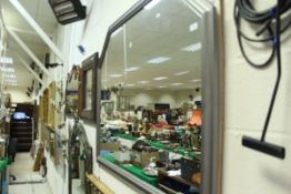 A large silver painted wooden framed mirror