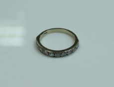 An 18 carat white gold and diamond set half eternity ring, size P, 0.3 carat total, 2.