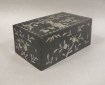A Chinese mother of pearl inlaid rectangular lidded box with all over floral spray and flowers in a