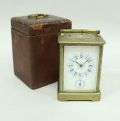 A circa 1900 French brass cased carriage clock with visible escapement and alarm (alarm mechanism