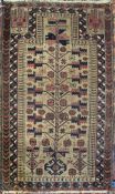 A Belouch tribal rug, the central panel set with stylised flower head design on a fawn ground,