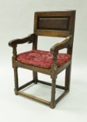 An 18th Century oak armchair,