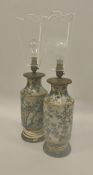 A pair of 19th Century Chinese cloisonné vases with bird and blossom decoration on a white ground