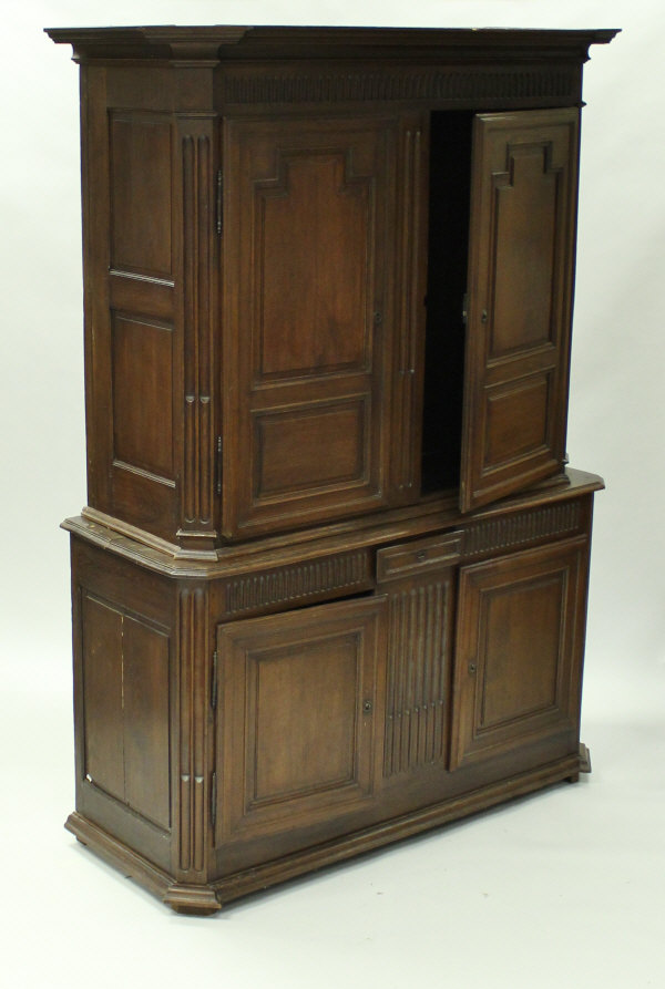 A 19th Century Continental oak cupboard with moulded cornice over two fielded panelled doors,