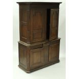 A 19th Century Continental oak cupboard with moulded cornice over two fielded panelled doors,
