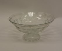 A Daum of Nancy clear glass bowl with ribbed decoration raised on a circular folded foot signed to
