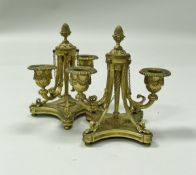 A pair of 19th Century French gilt bronze twin branch candle holders in the Regence style,