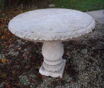 A modern carved stone circular pedestal table on baluster support in the 19th Century style,