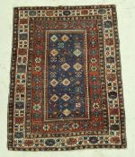 A Shirvan rug, the central panel set with repeating diamond motifs on a dark blue ground,