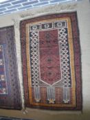 A Turkish prayer rug, the central panel set with pillar design on a brown ground,