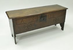 A 19th Century oak hutch, the plank top with moulded edge over a carved front inscribed "AS 1696",
