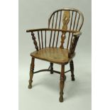 A 19th Century ash and elm low stick back elbow chair in the manner of Nicholson of Rockley on