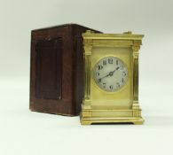 A circa 1900 French lacquered brass cased carriage clock with visible escapement the case with