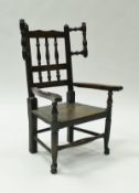 A 19th Century North Country child's beech and oak spindle back armchair with spindle wings,