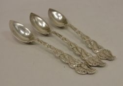 A set of three late 19th Century Tiffany grapefruit spoons with cast foliate handles inscribed