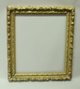 An early 18th Century carved gilt wood and gesso picture frame with flower head decoration bears