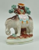 A rare 19th Century Staffordshire spill vase decorated with an elephant by a tree stump, 14.