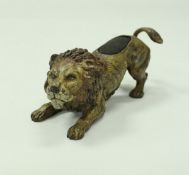 An Austrian cold painted bronze pin cushion as a crouching lion in the manner of Franz Bergman,
