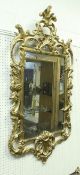 An 18th Century giltwood and gesso framed wall mirror in the Chinese Chippendale taste,
