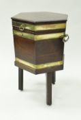 A George III mahogany wine cooler of hexagonal brass bound form,