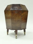 A late George III mahogany wine cooler of octagonal form,